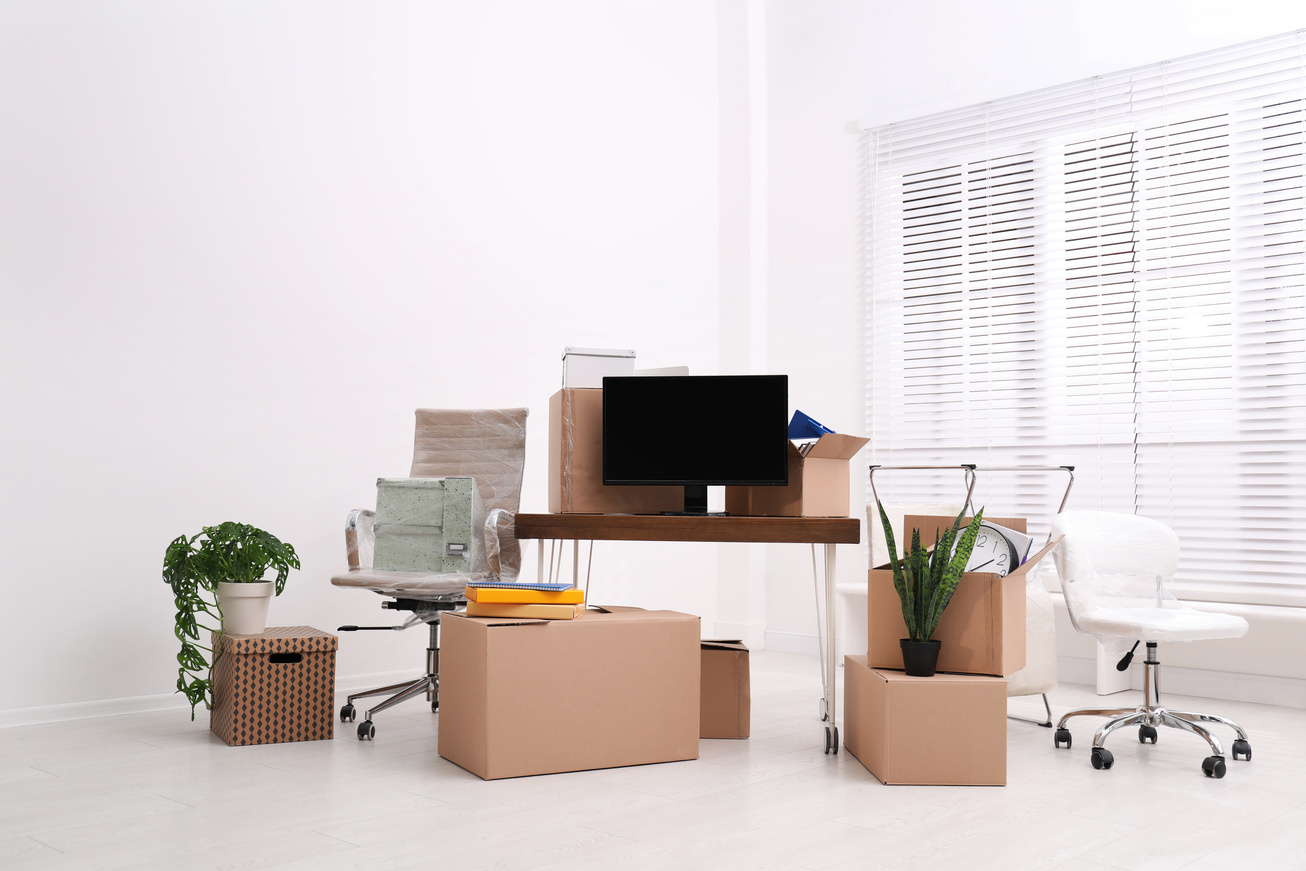 Cardboard Boxes and Packed Belongings in Office. Moving Day